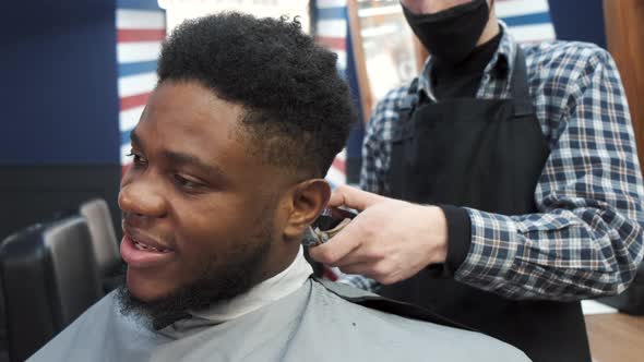 Young Africanamerican Man Visiting Barbershop for Haircut