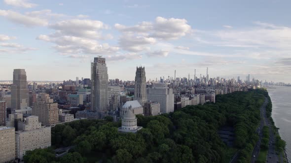 Aerial view around the Riverside church and the shoreline of Upper Manhattan, partly sunny day in NY