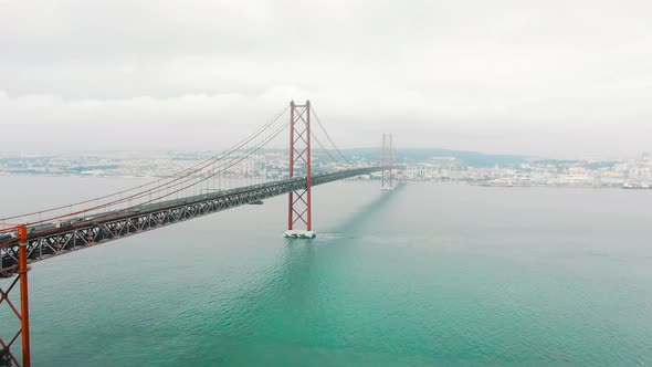 Cars Drive Along Long Red Ponte De April Lisbon Bridge