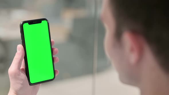 Holding Smartphone with Green Chroma Screen