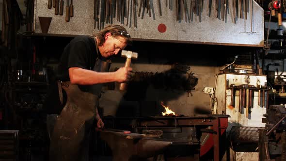 Blacksmith working on a iron rod