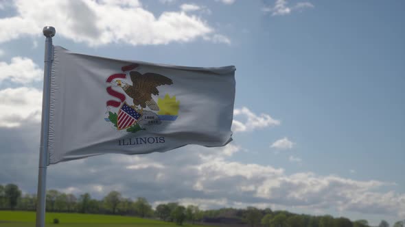 Illinois Flag on a Flagpole Waving in the Wind in the Sky
