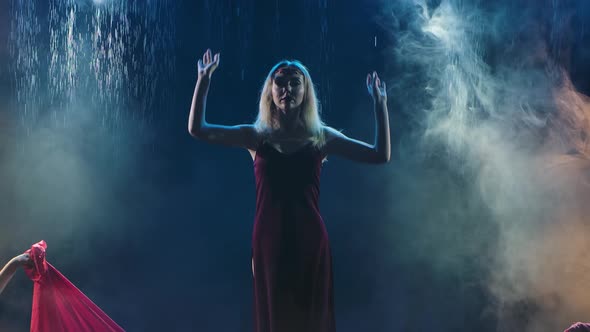 Passionate Dance of Group Females with a Silk Red Cloth in the Rain. Women Dance on the Surface of