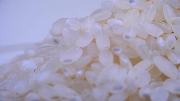 Grains of Raw Rice Rotate Close-up