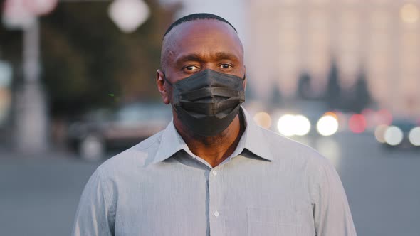 Adult Mature African American Man Wearing Black Protective Medical Face Mask Posing Outdoors