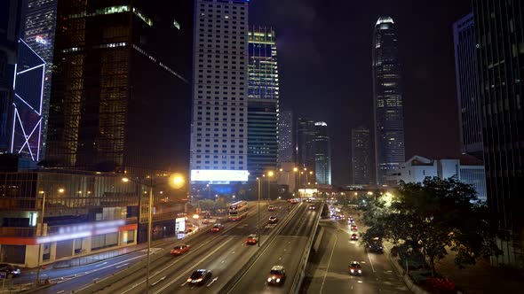 Hong Kong, China. Evening Car Traffic with Skyscrapers in the Background. Cars and Buses