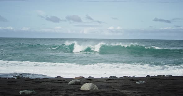 In the Middle of the Beach Taking Video of the Sea