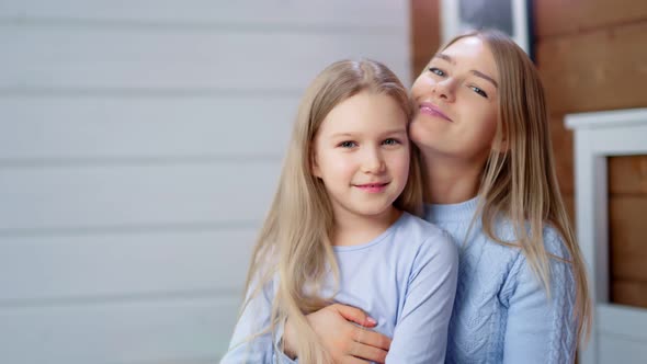 Medium Closeup Happy Young Mother Kissing Enjoying Having Good Time Cute Little Daughter