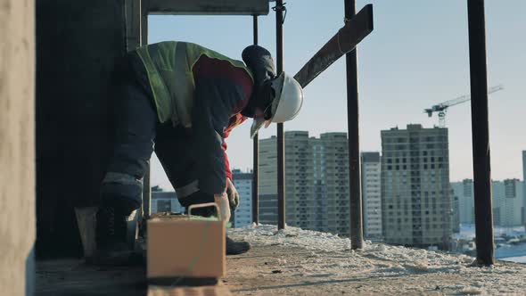 A Worker Is Fixing Bricks in Lines in a Multistory House in Progress