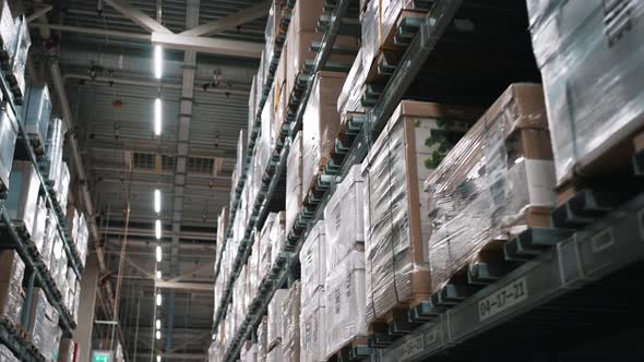 High Racks with Boxes on Shelves Wrapped in Polyethylene