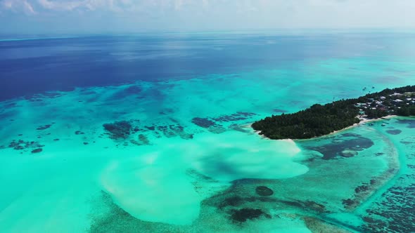 Aerial flying over panorama of marine island beach vacation by blue sea with white sand background o