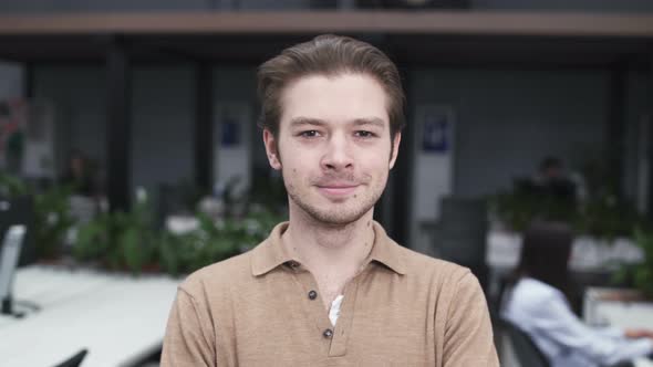 Happy Young Employee Looking At Camera And Smiling