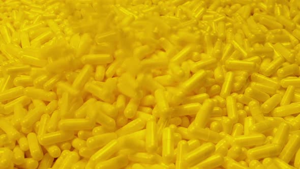 Yellow Supplement Capsules Poured In Pile