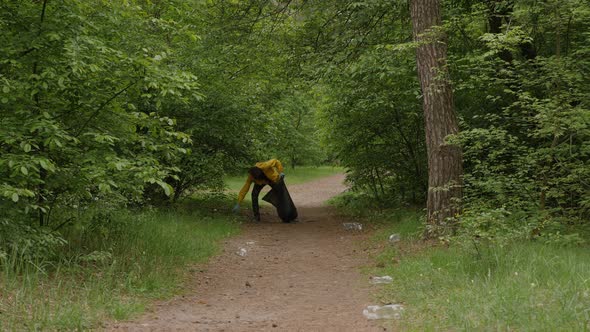 Environmental Conservation Volunteer Cleaning Up a Forest