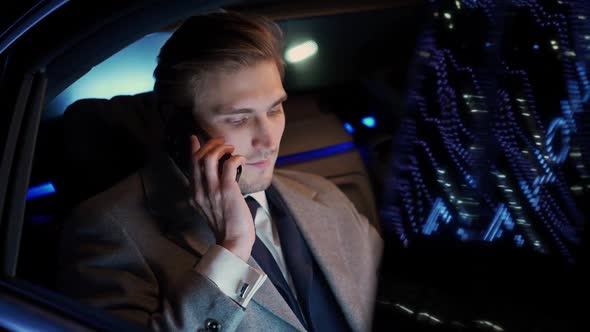 Handheld Businessman Sitting in a Moving Car Talking on a Mobile Phone and Using Laptop Man Top