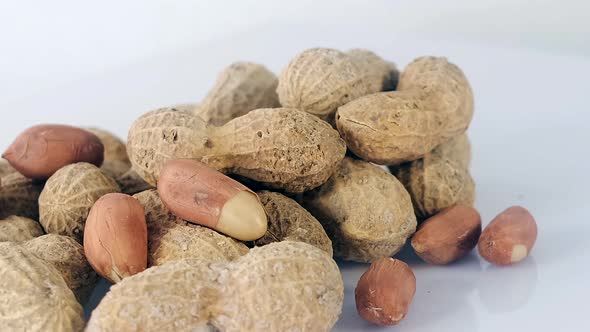 Peanuts rotating on white background - shelled peanuts