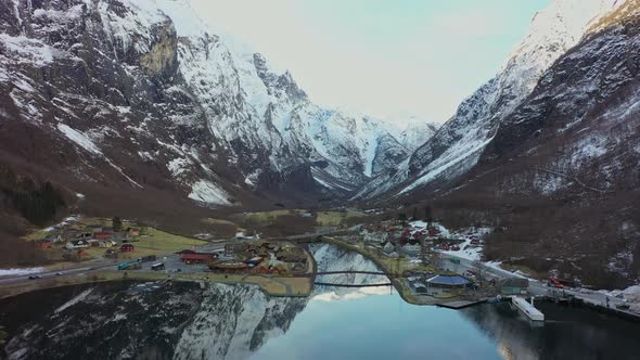 Spectacular Gudvangen village by Unesco Naeroyfjord during cold winter morning - Downwarding aerial