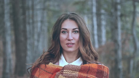 Slow Motion Portrait of a Young Beautiful Woman Whose Hair Sways in the Wind While the Look