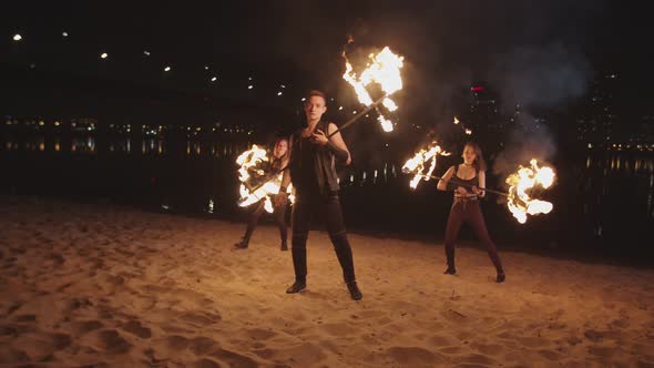 Man Rolling Flaming Staff During Night Fire Show