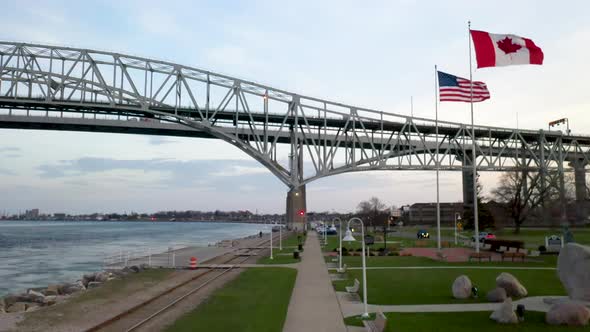 Bluewater Bridge connecting Port Huron, Michigan USA and Sarnia, Ontario Canada with flags waving.