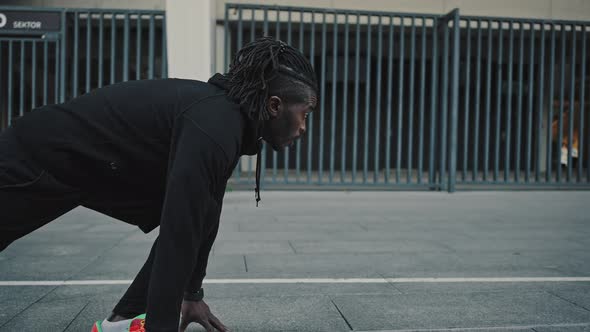 Active African American Man Sprinter Standing in Start Position and Run Fastly Preparing for