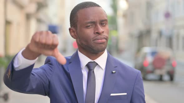Outdoor African Businessman Showing Thumbs Down Gesture