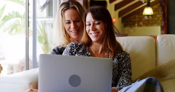 Lesbian Couple Using Laptop on Sofa 4k