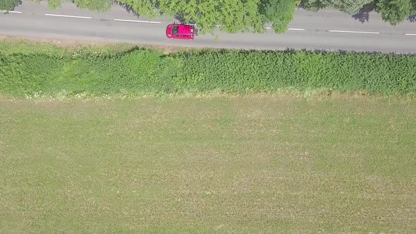 Aerial overhead view of cars driving along a rural road in Devon, England, STATIC CROP