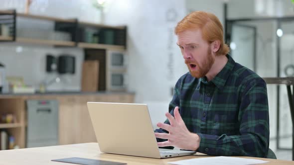 Beard Redhead Man Reacting To Loss on Laptop in Cafe, Failure