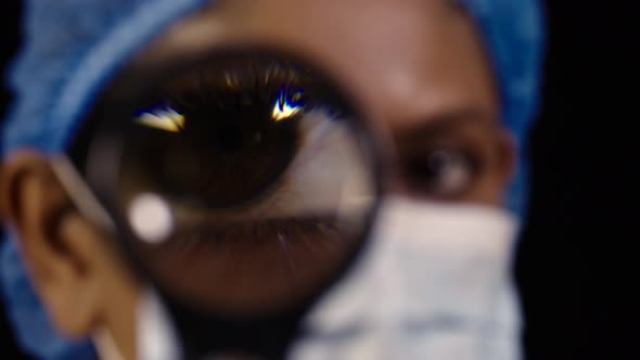 Female Lab technician with Magnifying Glass