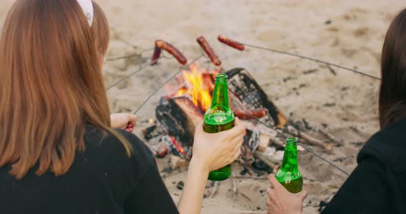 Young Teen Woman Happy Friends Camping in Nature Having Fun Together Drinking Beer and Clinking