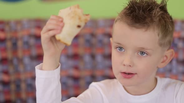 Little boy eats delicious pizza. Italian pizza