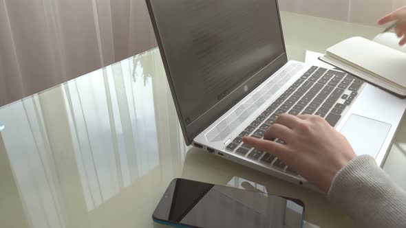 The girl working at home office hands on keyboard.