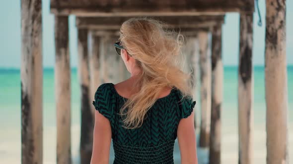 Dreamy Woman Smiling And Relaxing On Beach. Stress Free Girl In Summertime Season Sundress Leisure.