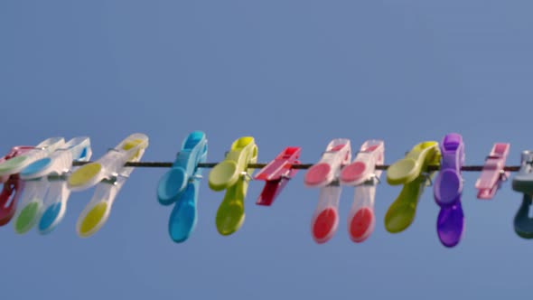 4K video of colourful clothespins on a rope in the garden