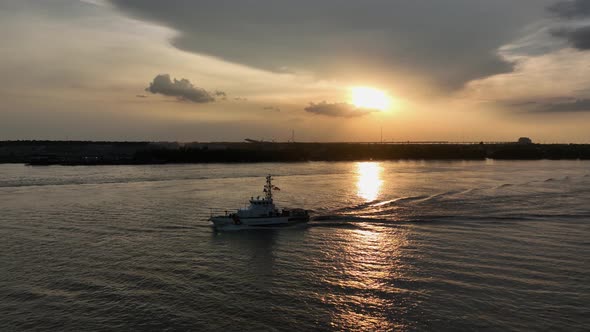 Coast Guard on patrol on the busy Mississippi River at sunset