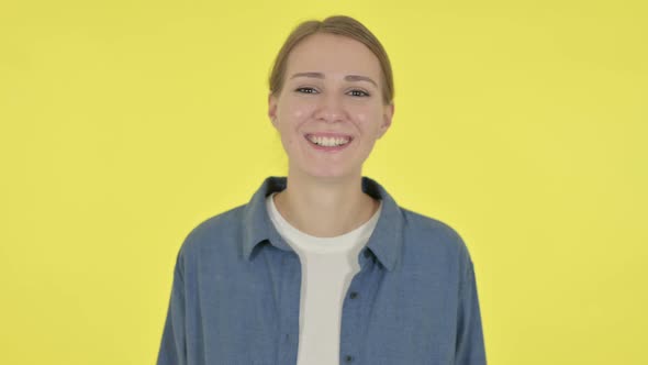 Young Woman Talking on Online Video Call on Yellow Background