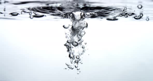 Water drips into a water surface - white background