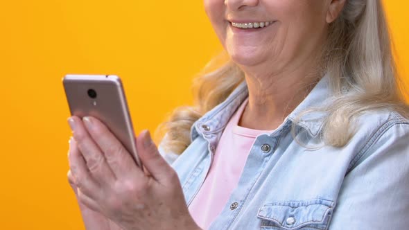 Old Woman Scrolling Smartphone Application and Smiling Camera, Social Networks