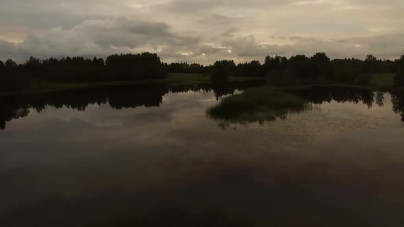 Aerial view of a small lake with stormy sky in Estonia.