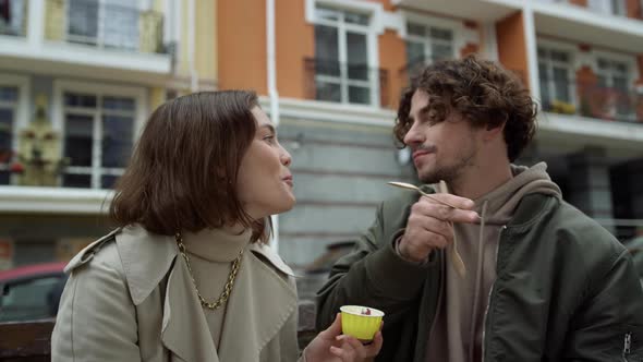 Cheerful Couple Eating Ice Cream Outdoor