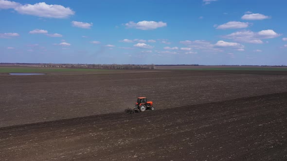 Tractor Cultivating Field Aerial View