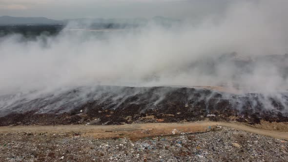 Aerial sliding over rubbish dump site burning