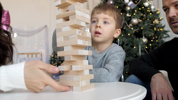 Family is Playing in Wooden Tower at Home