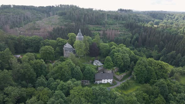 close up circular drone shot of Wildenburg Castle in the southeast of the village of Friesenhagen in