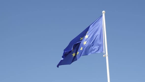 Slow motion of EU flag waving against blue sky 1920X1080 HD footage - Famous European Union state sy