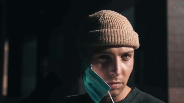 Portrait of a Young Caucasian Man Putting on a Protective Mask. Concept of Health and Safety Life