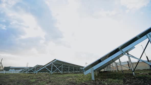 Innovative solar farm. Metal constructions with sunny batteries on the ground.