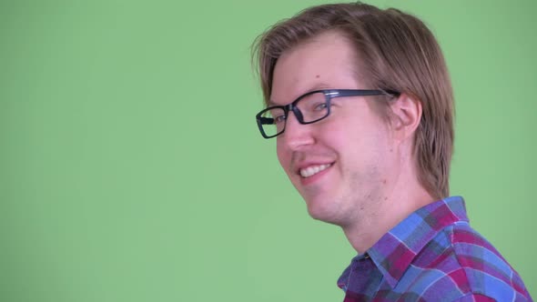 Closeup Profile View of Happy Young Hipster Man Looking at Camera