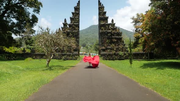 Woman Runs to Balinese Gates in Dress Slowmotion